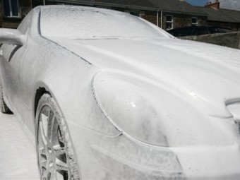 Car is covered in a blanket of foam.